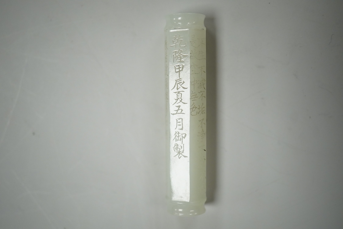 A Chinese pale celadon jade inscribed cylinder bead, 6.5cm long